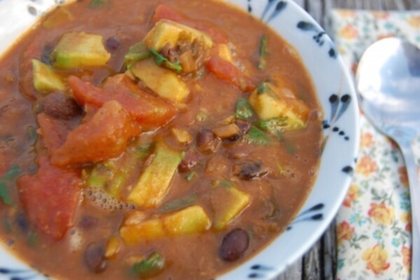black bean avocado soup in a blue and white bowl