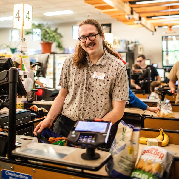 smiling cashier at a register