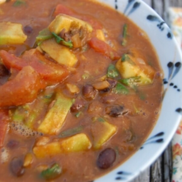black bean avocado soup in a blue and white bowl